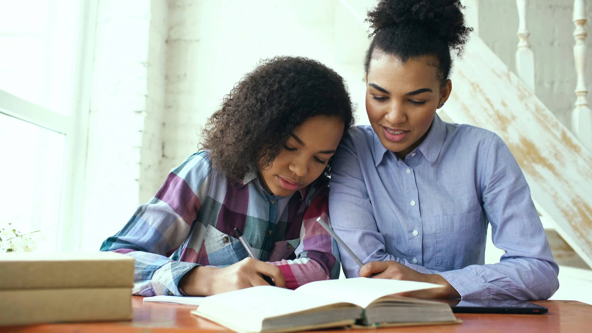 African parent supporting a student with schoolwork
